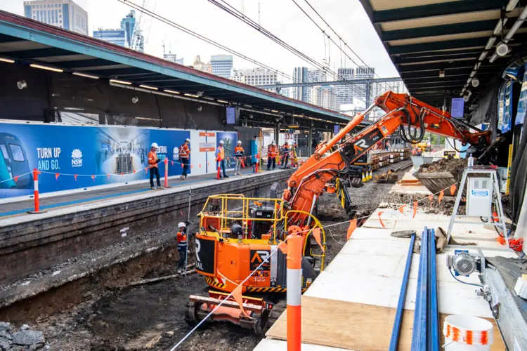 Heavy machinery is being used to reinforce the railway track which is above the future central walk.