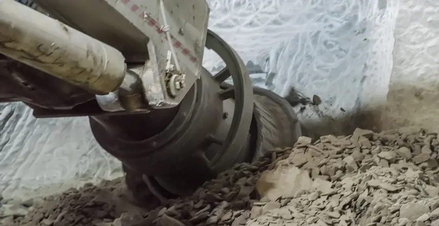 A close up shot of the Roadheader in action as it breaks apart a wall with shattered material beneath it at Sydney Metro's Pitt Street North construction site.