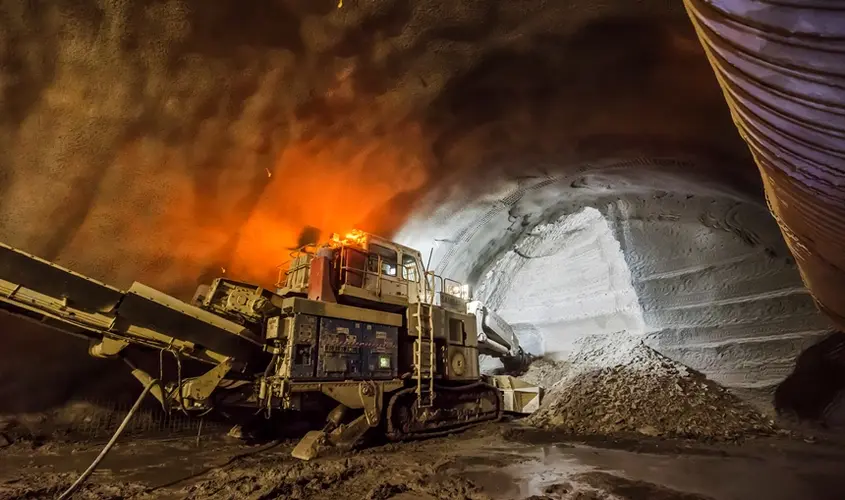 An on the ground view inside the tunnel at Sydney Metro's Pitt Street North construction as a Roadheader begins work withs its light on inside the tunnel. 