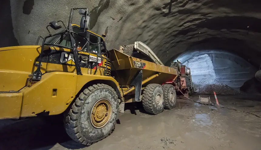 An on the ground view inside the tunnel at Sydney Metro's Pitt Street North construction site with a close up shot of a Roadheader inside the tunnel. 