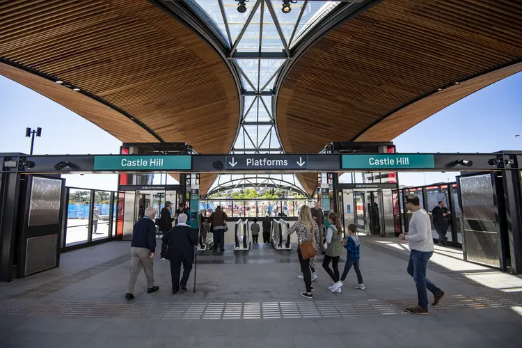 People are walking through the Opal turnstyles into Castle Hill Station on a Metro community day.