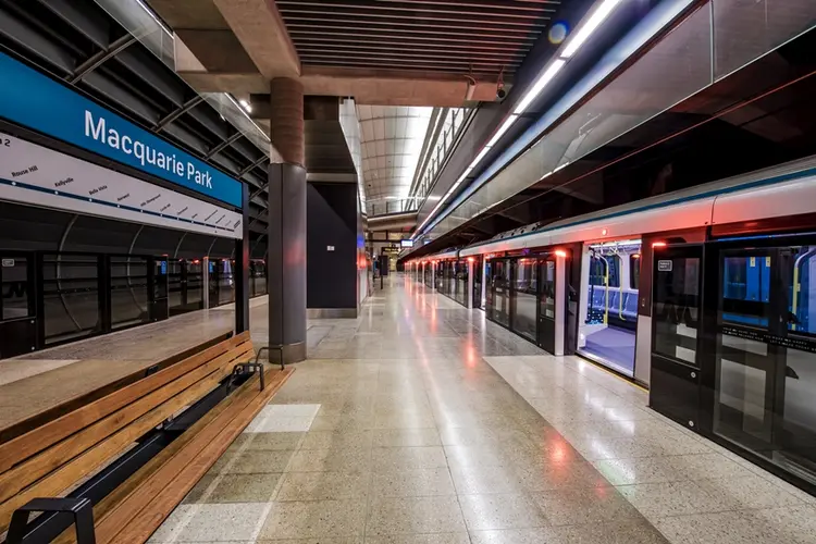 An artist's impression from the platform behind the screen safety doors opened as a train has stopped at the platform showing the platform benches at Sydney Metro's Macquarie Park Station.