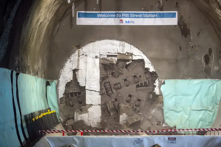 The cutterhead of a tunnel boring machine can be seen breaking through the wall at Pitt Street Station