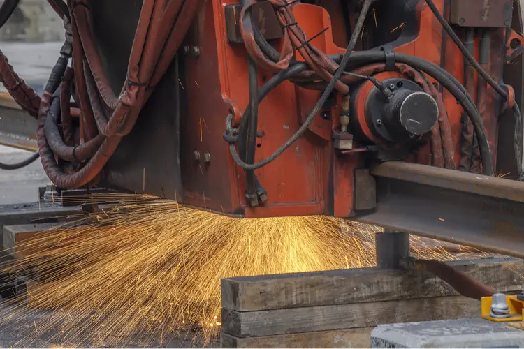 Machinery welding rail track at Waterloo Station. Sparks can be seen underneath the machine