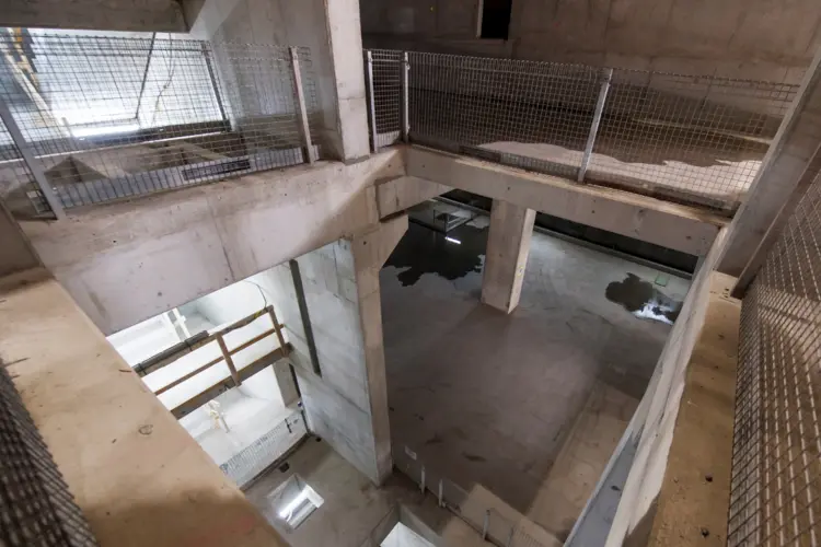 A view from above looking down into the Chatswood Dive cassette structure. Metal fencing protects workers from falling down.