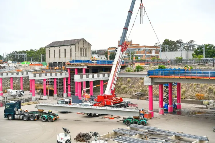 A wide shot of the aqueduct at Sydenham during construction. A large crane and heavy machinery are on site.