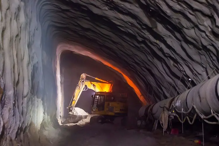 A digger machine is working inside the Barangaroo crossover cavern construction site.