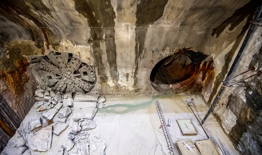 An aerial view into the cavern where two TBMs (tunnel boring machines) have broken through the cavern wall to make way for train tunnels.