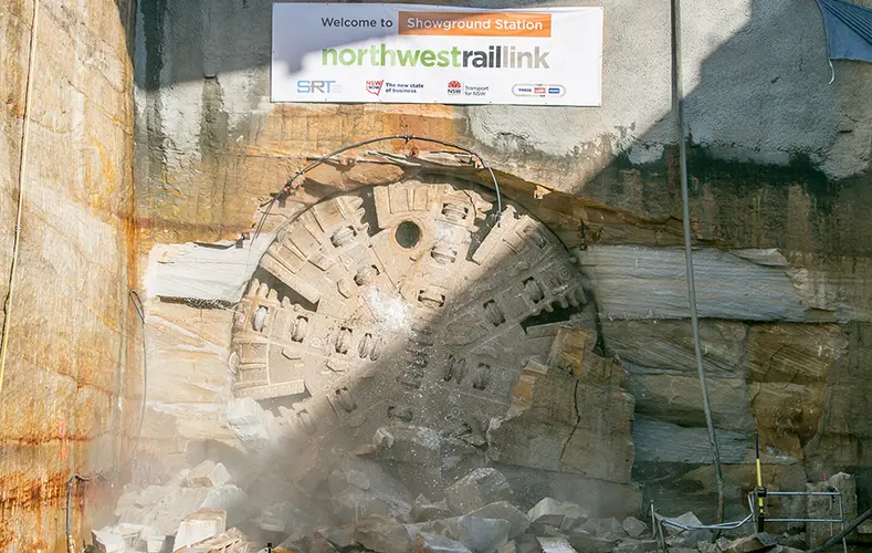 An on the ground view showing Tunnel Boring Machine (TBM) 1 Elizabeth final break through the stone at Sydney Metro's Hills Showground Station. 