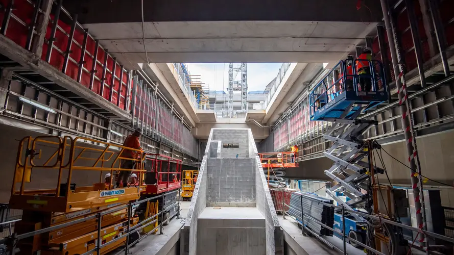 Ground level view of construction workers working on Sydney Metro's Waterloo Station platform level.