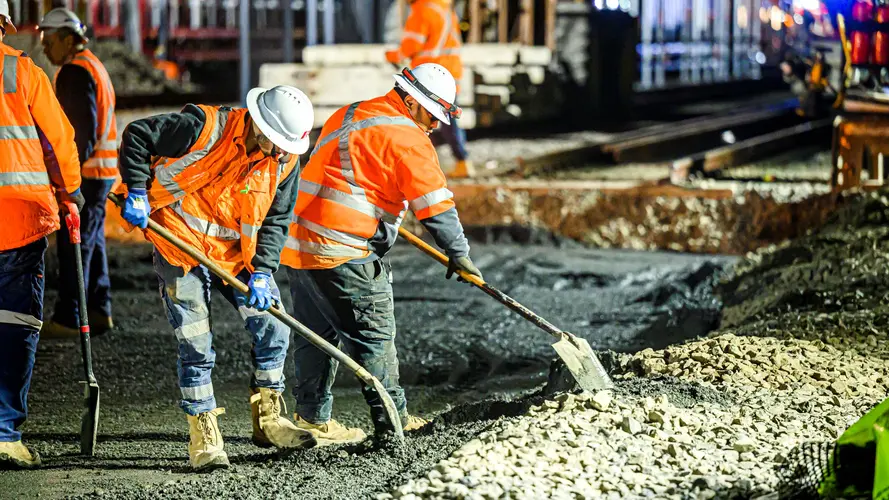 Construction workers laying concrete at Sydney Metro's Chatswood Station