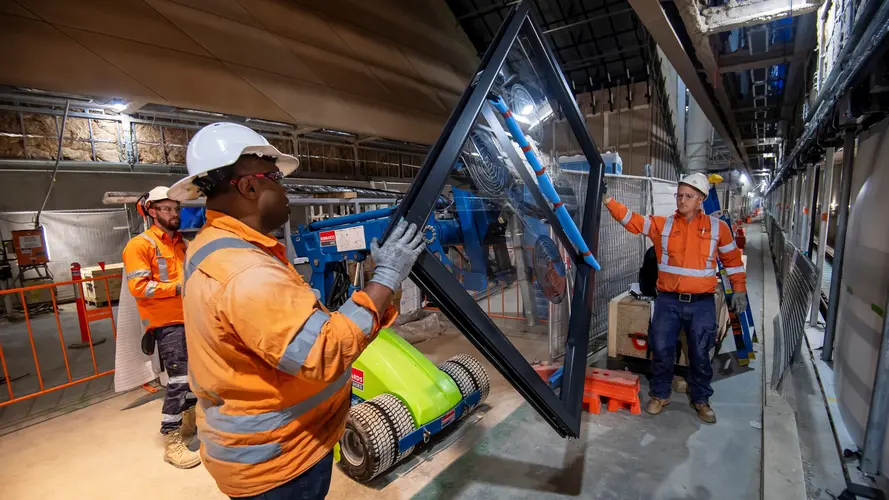 Construction workers installing platform screen doors at Central Station. 