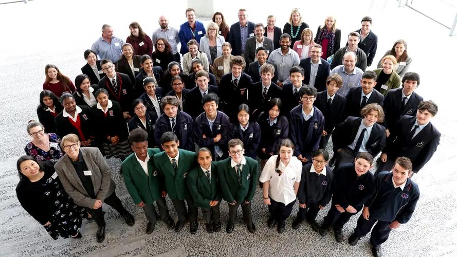 An aerial view group photo of Sydney Metro staff, teachers and students involved in the competition.