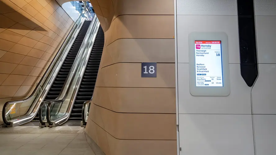 Wide shot of escalators at Central Station's new underground concourse to platform 18