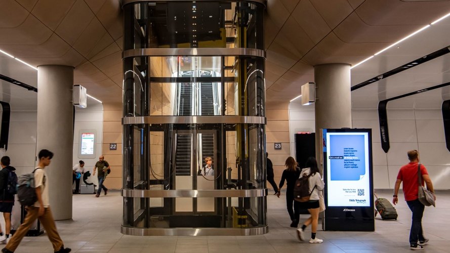 An Artist's impression of commuters travelling along Central Walk in front of the glass elevator at Sydney Metro's Central Station