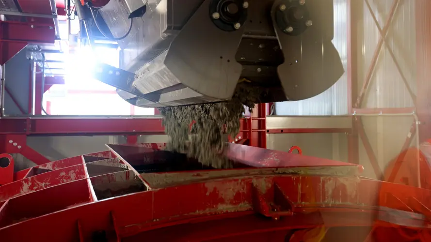 Concrete is being poured in a red segment mould.