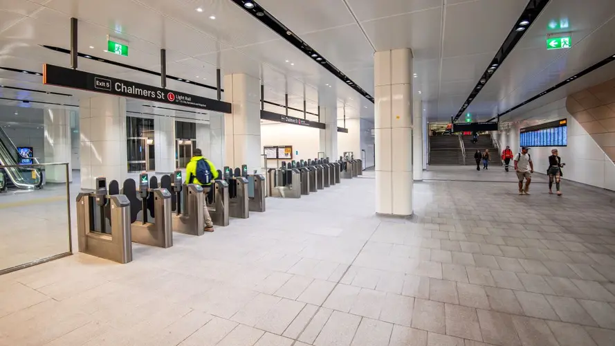 An enside of Central Station from the Chalmers street entrance with opal gates and signage of the station name