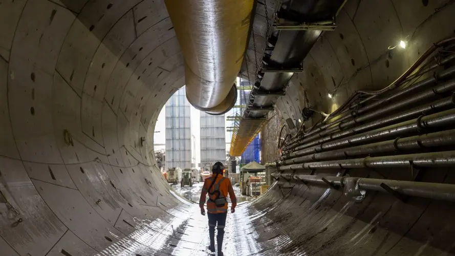 A worker is exiting a tunnel at The Bays