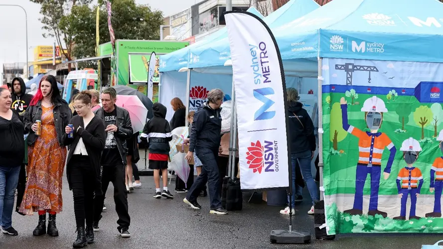 people walking around in a Sydney Metro event with marquees in the site