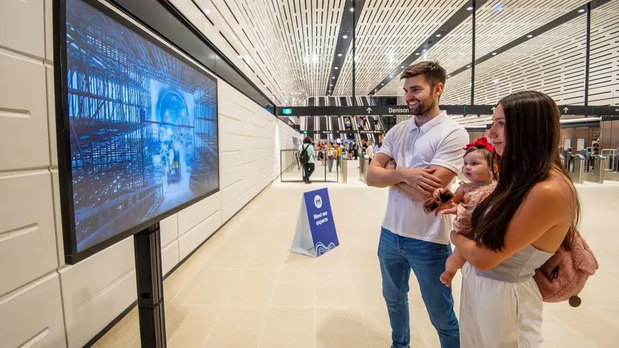 Couple looking at a screen showing construction