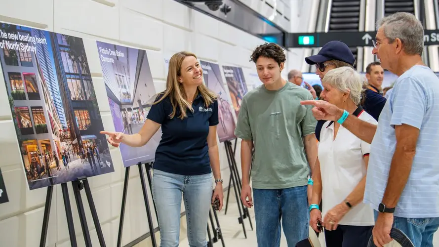 Lady pointing at a sign showing a group of people