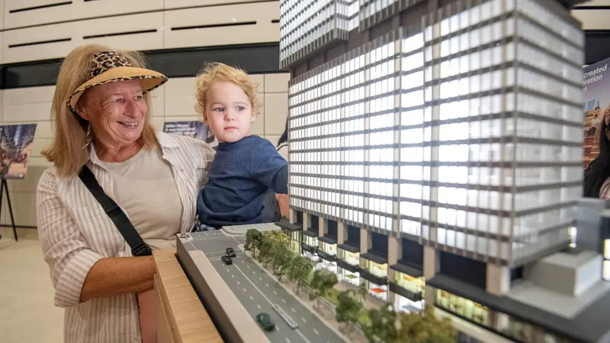 Lady and child looking at the station model