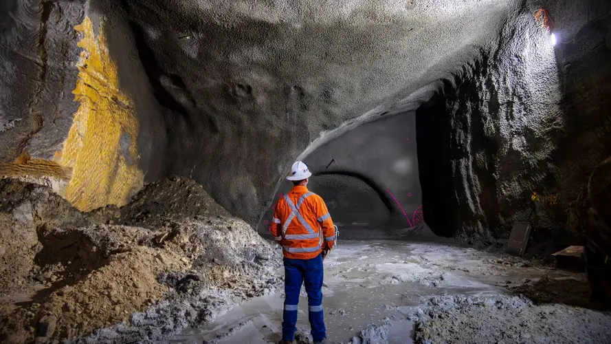 Man in High Vis gear looking at the cavern