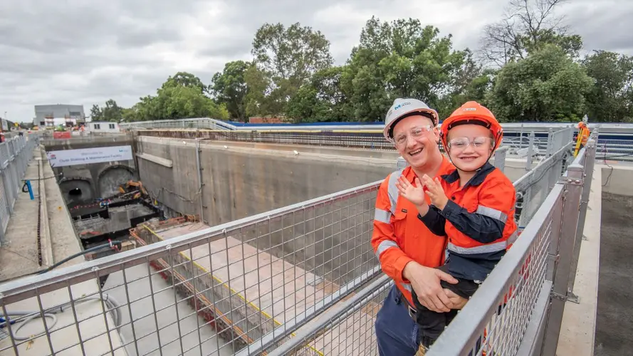 Man holding young boy above the tunnels