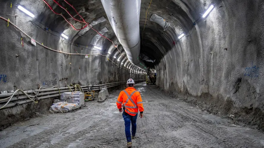 Man walking through tunnel in Hi Vis gear