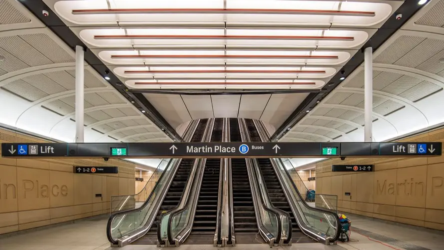 4 Escalators with the Martin Place sign in front