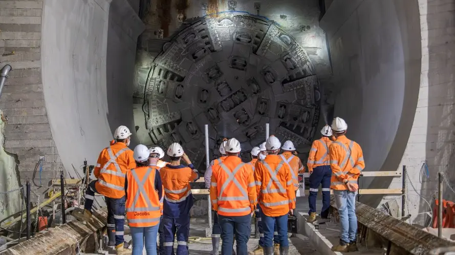 A group of people in high vis standing in front of the breakthrough