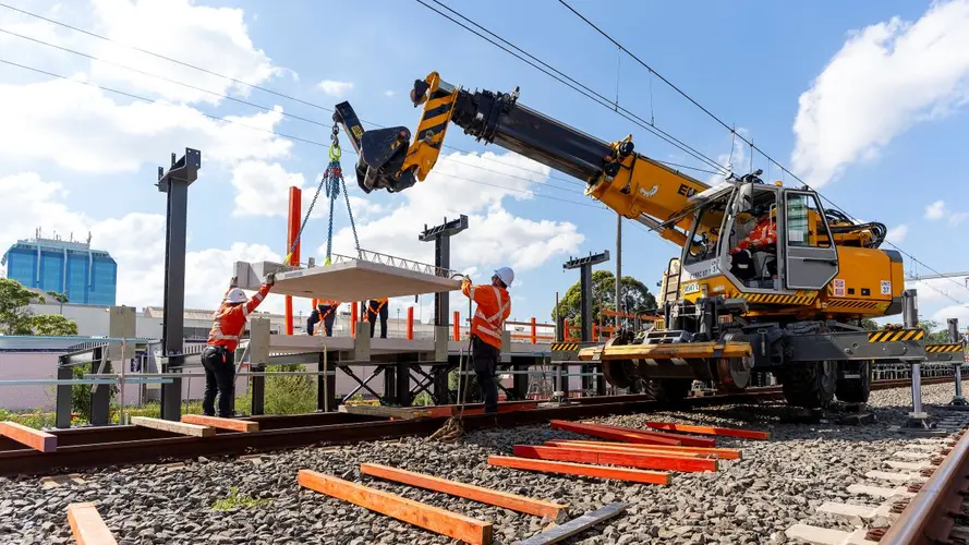 Image of large yellow machine installing the the metro platform at the Bankstown station