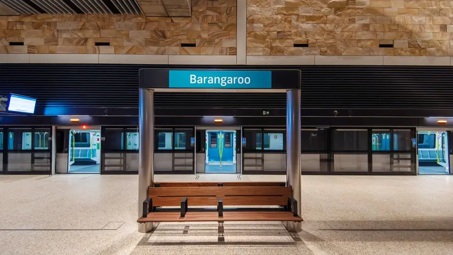 Barangaroo station platform sign with the platform screen doors open behind it opening to a Metro train