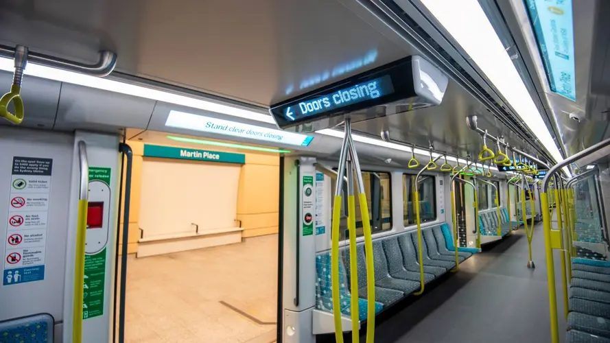 Metro train with doors open leading to Martin Place station platform