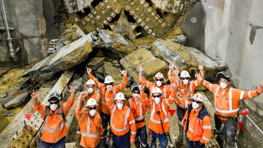 Group of Sydney Metro employees in front of the TBM breakthrough at St Marys