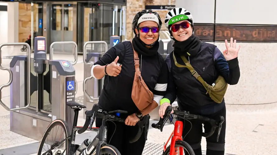 two people with a bike at the metro station