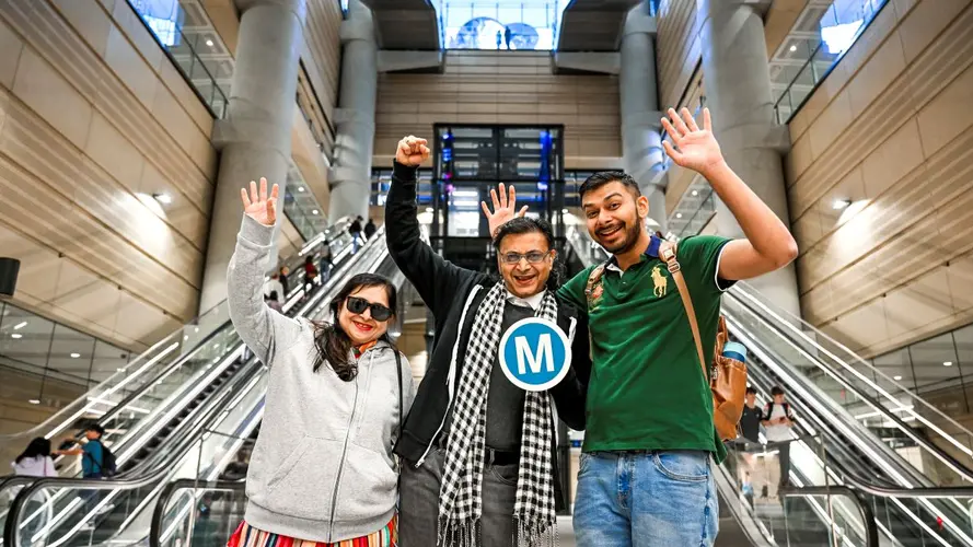 people holding the M logo at a metro station